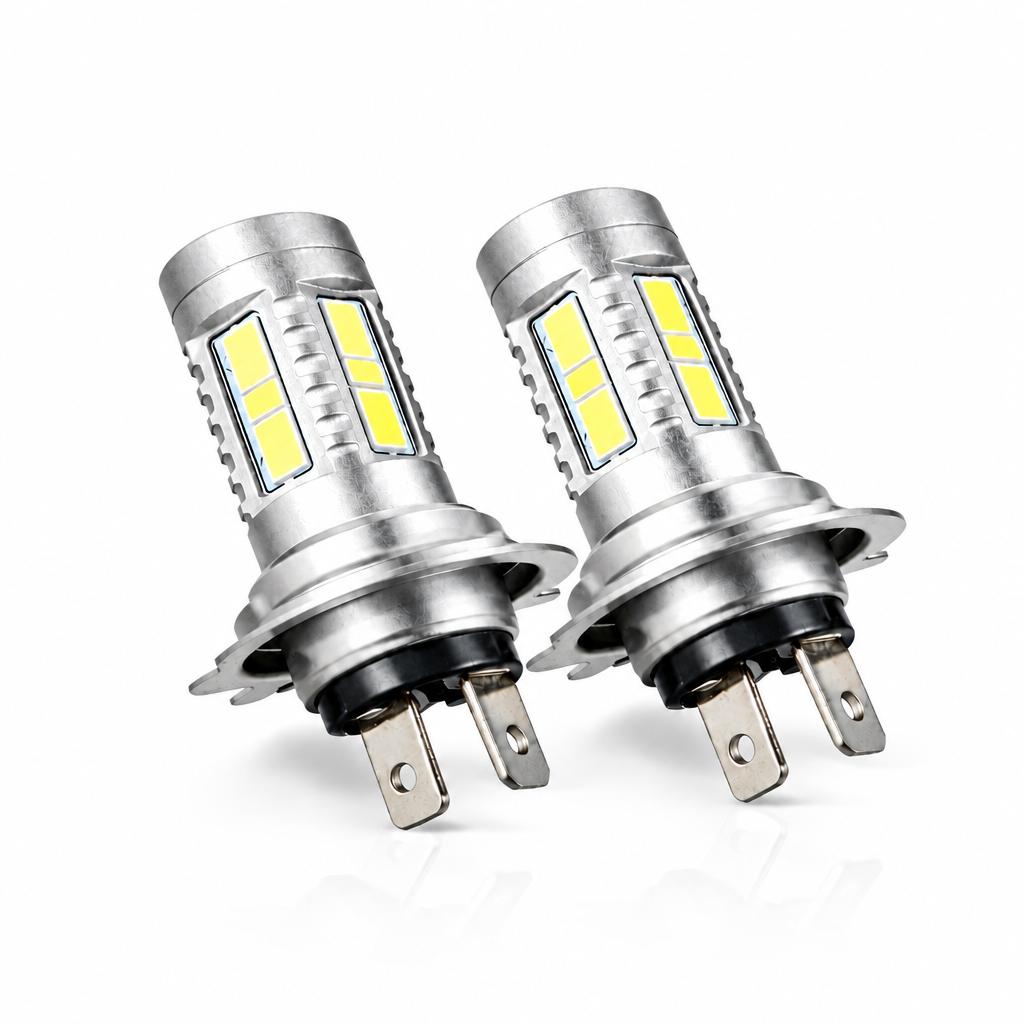Two LED car bulbs in front of their packaging box on a white background
